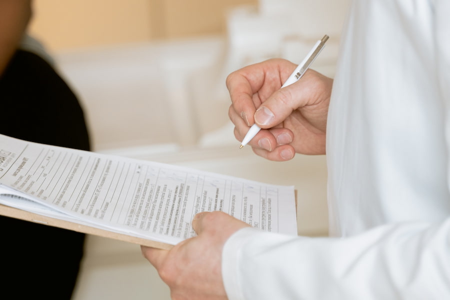 Pharmacist taking notes during a consultation